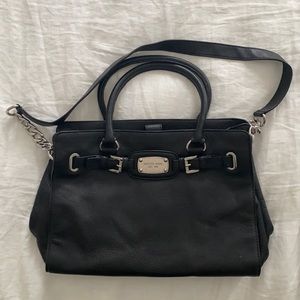 Black Michael Kors leather satchel with shoulder strap.